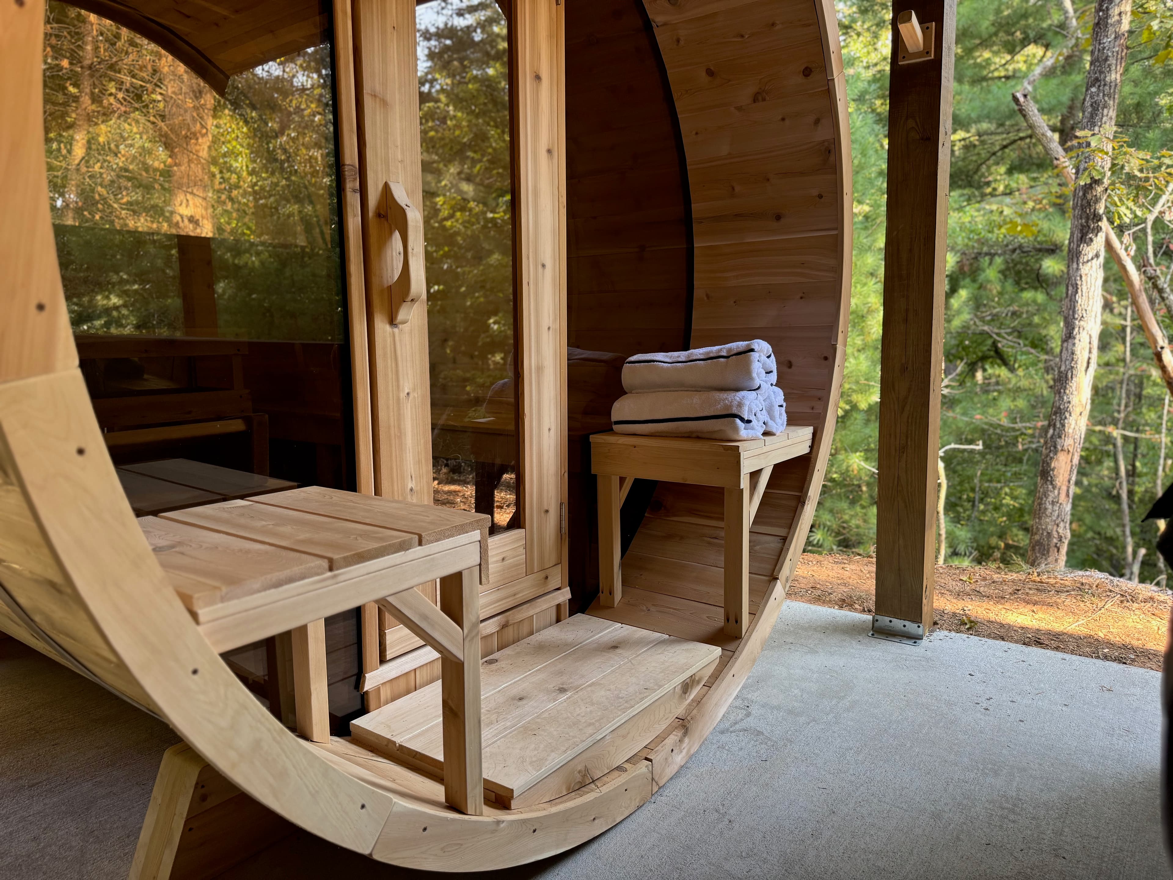 Inside the cedar barrel-vault spa room, looking out to the forest