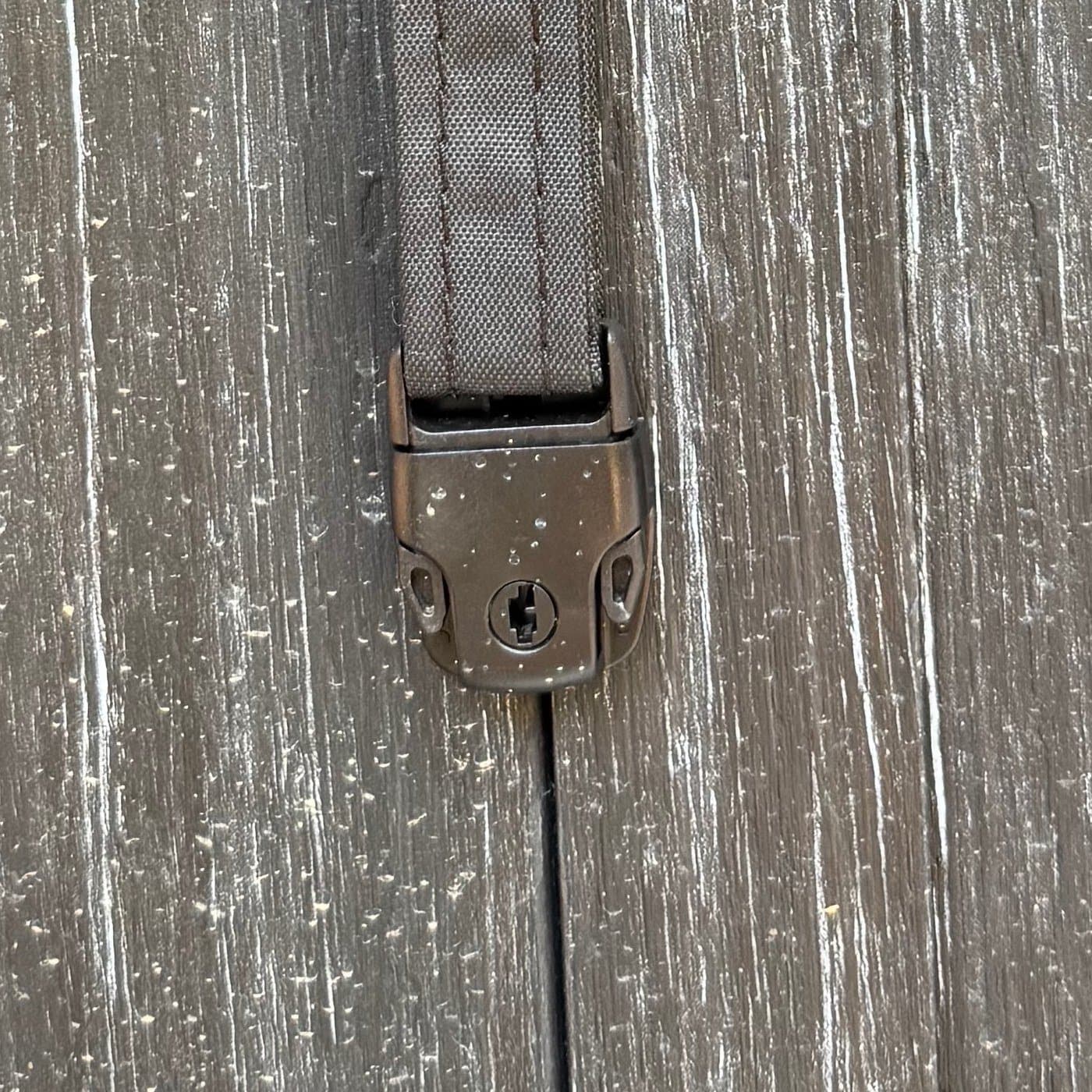 Close-up of one of the four hot tub cover buckles, unclipped