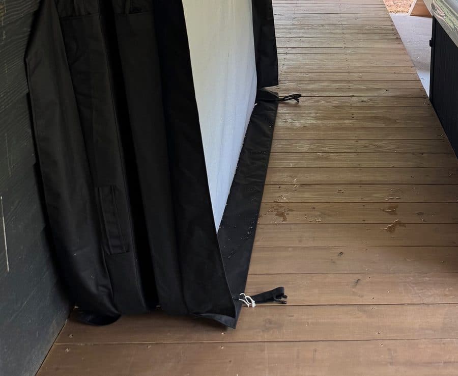 Hot tub cover lifted and leaned against the house wall