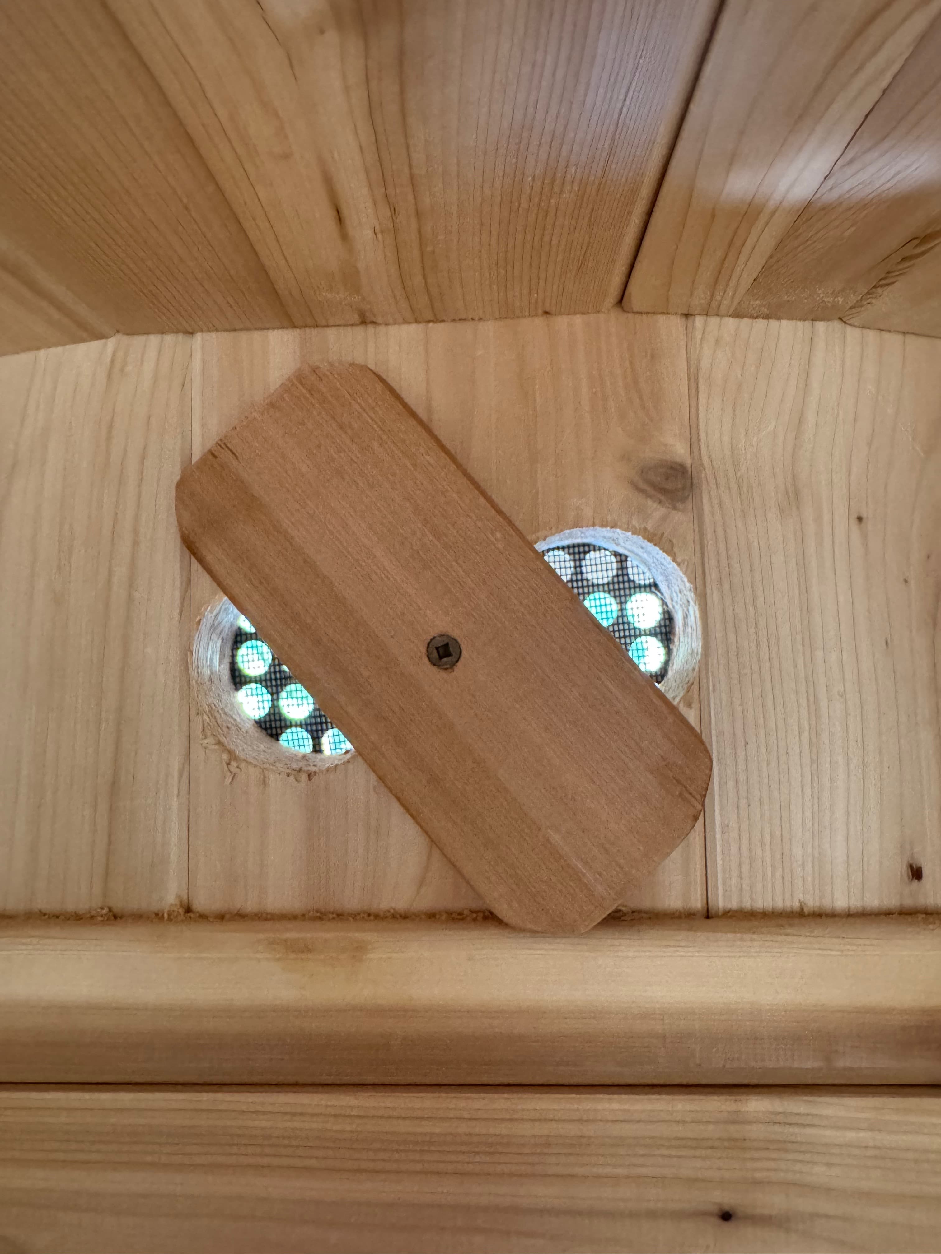 Round airflow vent above the sauna door